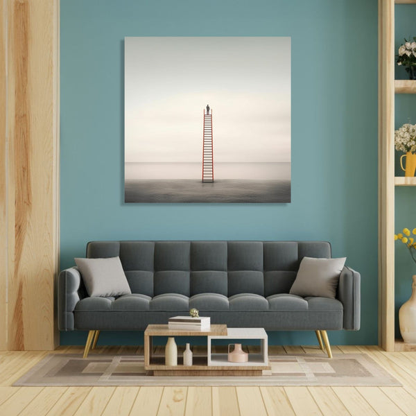 A person standing on top of a ladder, which starts on ground and has top in air, plain ground and sky bakground